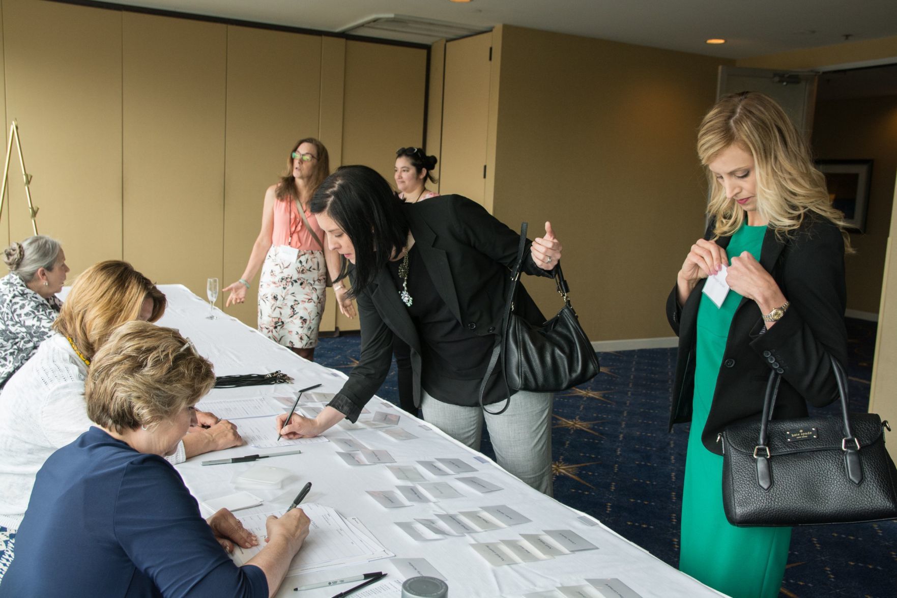 Attendees check in to the luncheon.